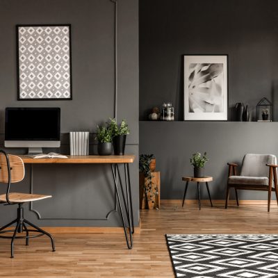 Posters,On,Grey,Wall,Above,Wooden,Desk,With,Computer,Monitor